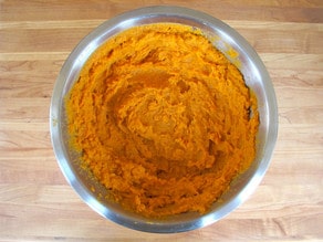 Mashed sweet potatoes in a mixing bowl.