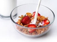 A bowl of healthy cereal with fresh fruits and milk, is a nutritious choice for a balanced breakfast