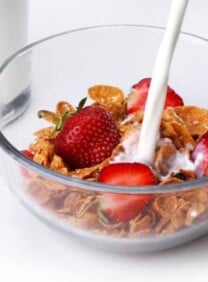A bowl of healthy cereal with fresh fruits and milk, is a nutritious choice for a balanced breakfast