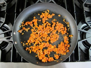 Chopped carrots in a skillet.