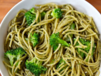 A plate of delicious broccoli pesto pasta, topped with broccoli and fresh basil pesto pasta
