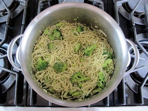 Cooking delicious broccoli pesto pasta on the stove