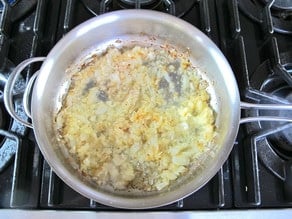 Sauteeing onion in a skillet.