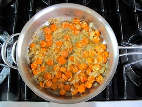 Carrots with onions in a skillet.