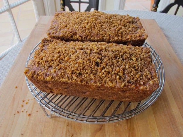 Two loaf cakes cooling on a rack.