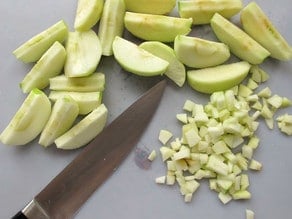 Finely diced apple on a cutting board.