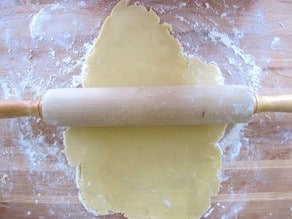 Rolling out cookie dough on a floured surface.