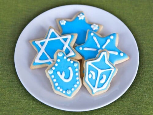 Holiday sugar cookies with colorful icing and festive designs served on a white plate