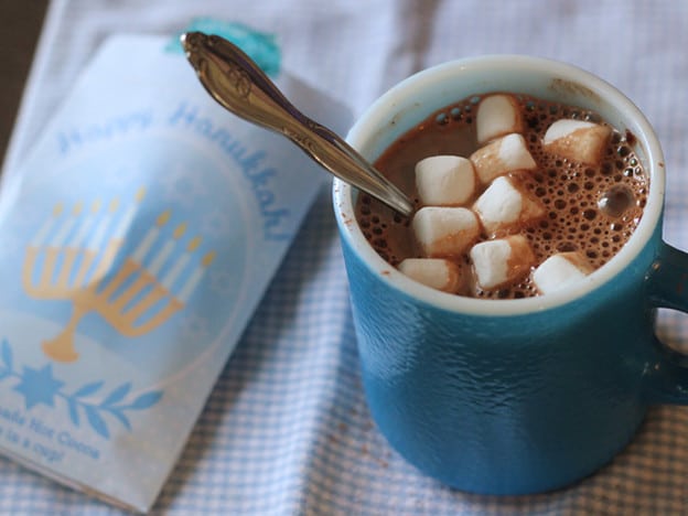 Adding marshmallows to hot cocoa.