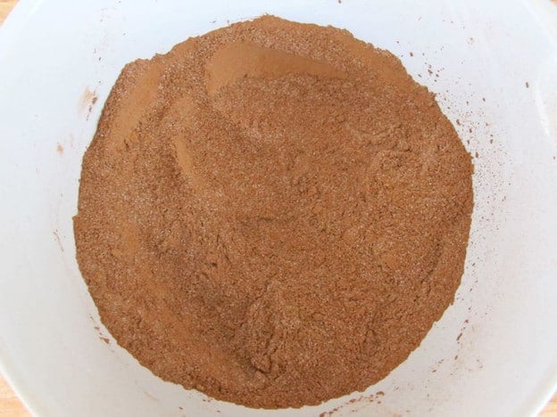 Measuring hot cocoa mix ingredients into a bowl.