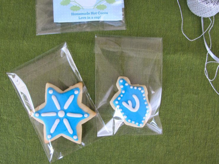 Decorated holiday sugar cookies with royal icing in cellophane bags, sealed.