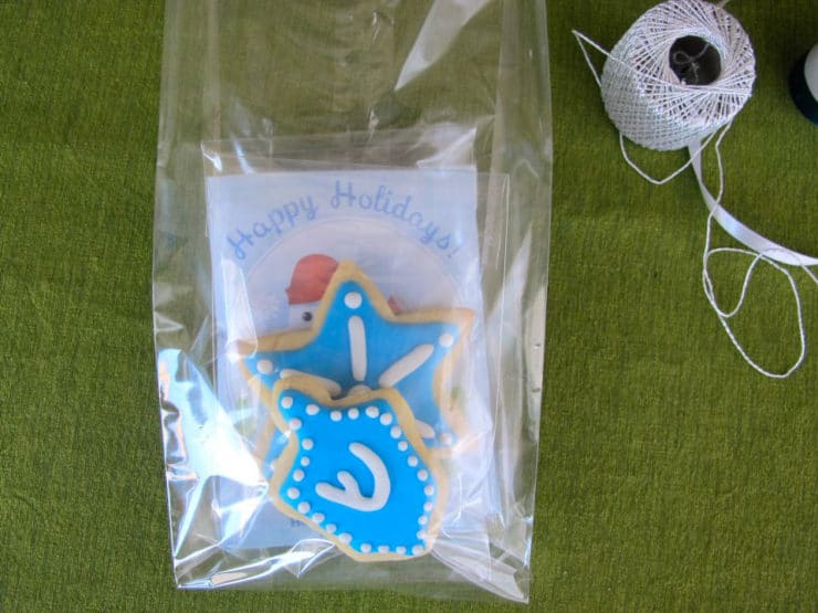 Hot cocoa pouches and sugar cookies packed in large cellophane bag. 