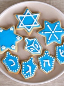 Overhead View - Plate of Hanukkah Holiday Sugar Cookies Decorated with Royal Icing on Beige Plate on Beige Tablecloth