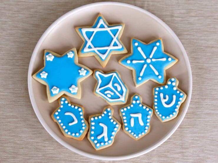 Overhead View - Plate of Hanukkah Holiday Sugar Cookies Decorated with Royal Icing on Beige Plate on Beige Tablecloth