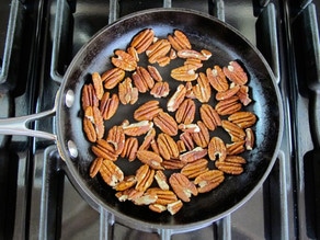 Dry toasting pecan halves in a skillet.