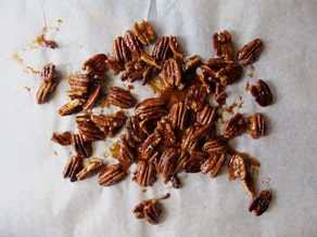 Candied pecans on wax paper to dry.