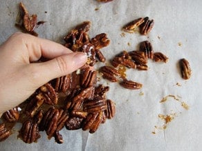 Breaking candied pecans into pieces.