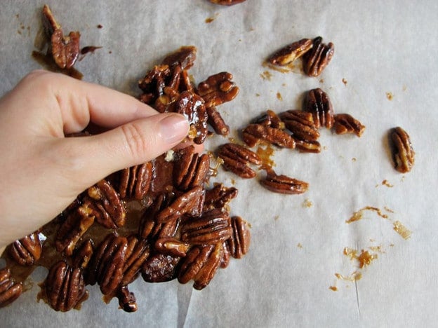 Breaking candied pecans into pieces.