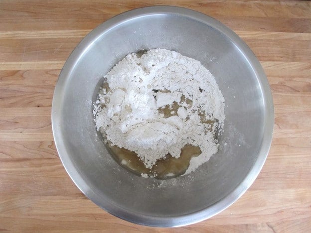 Powdered sugar and water in a mixing bowl.