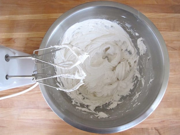 Beating icing in a bowl.
