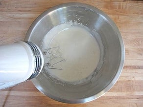 Beating icing in a bowl.