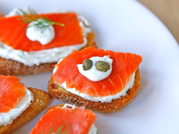 Salmon crostini topped with capers.