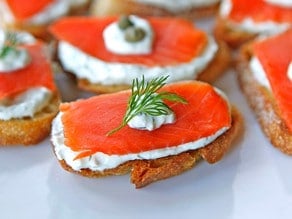 Salmon crostini topped with dill.