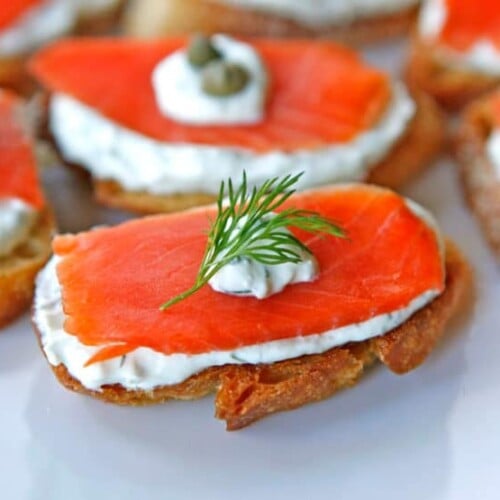 Salmon crostini topped with dill.