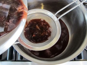 Straining spices from wine.