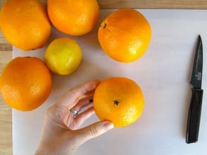 Sticking cloves into oranges.