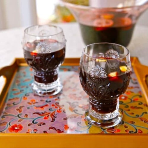 Close-up of smoking bishop drink served in a two fancy glasses on top of a nice looking tray