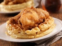 Fried chicken and waffles on a plate - a classic dish of crispy chicken and fluffy waffles, served together