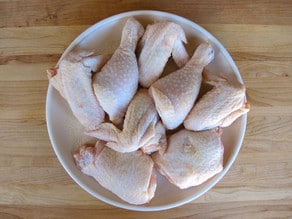 Seasoning chicken parts.