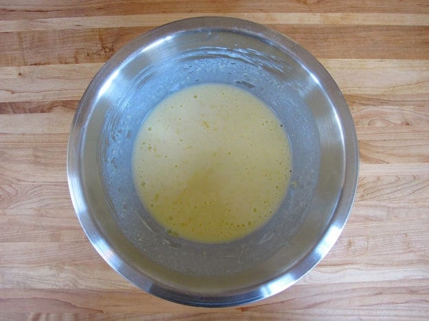 Wet ingredients for waffles in a mixing bowl.