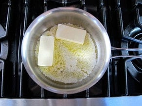 Two sticks of butter in a heavy-bottomed pan.
