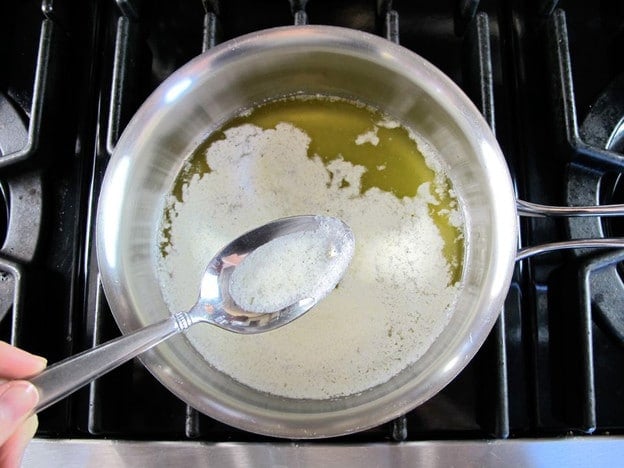 Skimming foam from melting butter.