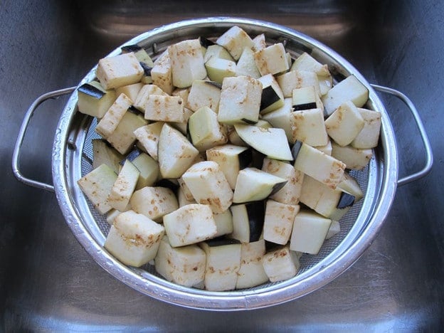 Cubed eggplant in a colander.
