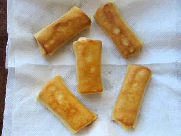 Blintzes draining on paper towel.