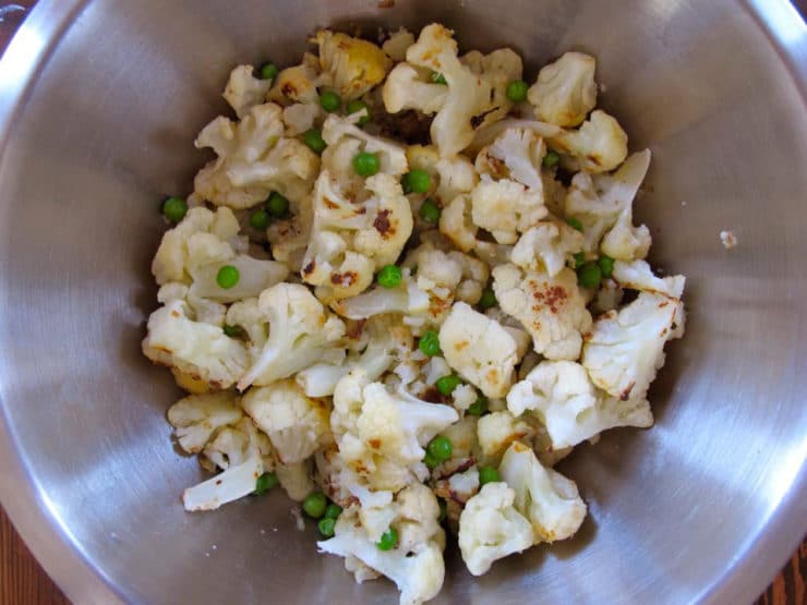 Roasted cauliflower in a mixing bowl.