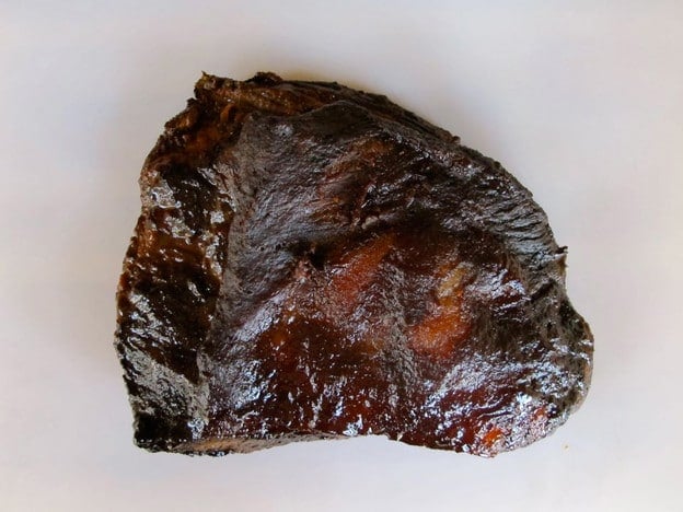 Cooked brisket on a cutting board.