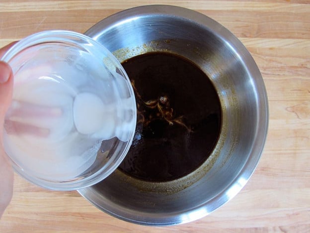 Whisking cornstarch into pan juices.