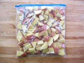 Potatoes and oil in a zipper top bag.