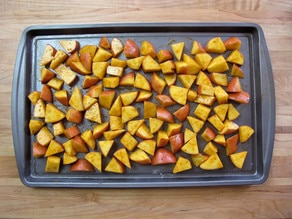 Seasoned potatoes on a baking sheet.