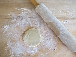 Rolling out dough circles.