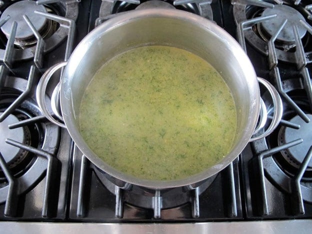 Tahini stirred into soup in stockpot.