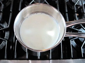 Warming milk in a saucepan.