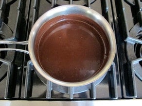 Melting chocolate into warm milk.