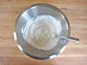 Whipping yogurt with a fork.