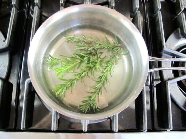 Bunch of herbs infusing boiling water.