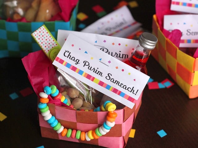 Purim Homemade Woven basket filled with beads necklace, bottle of a strawberry syrup and gifts